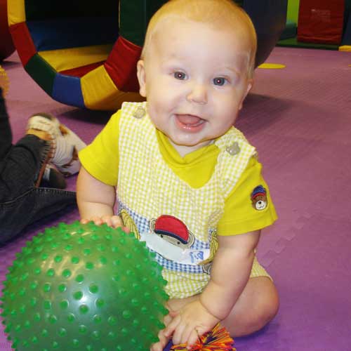 This sweet, smiling baby loves our baby activities in Charlotte.
