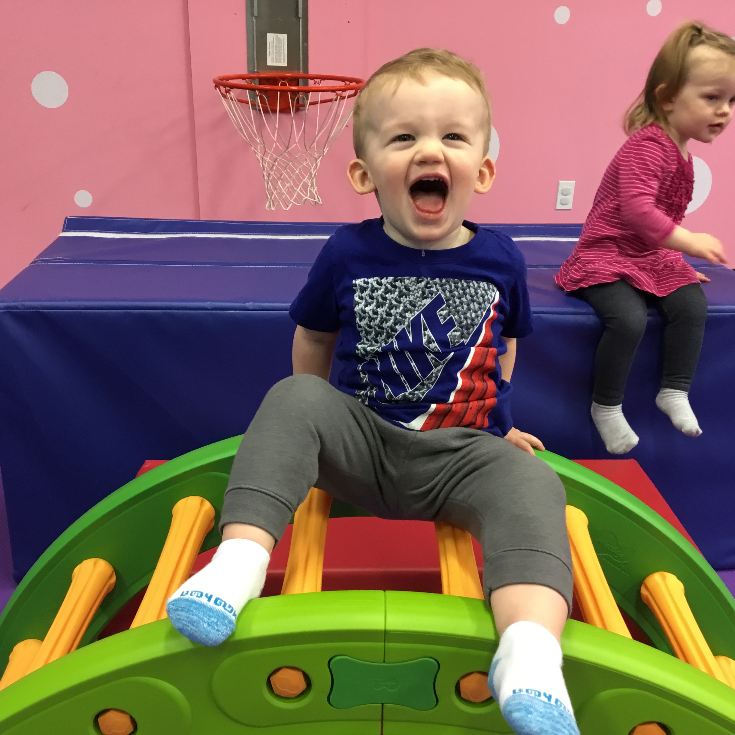 A little boy sitting at the table with his peers enjoying Romp n' Roll's toddler classes in Glen Allen, VA.