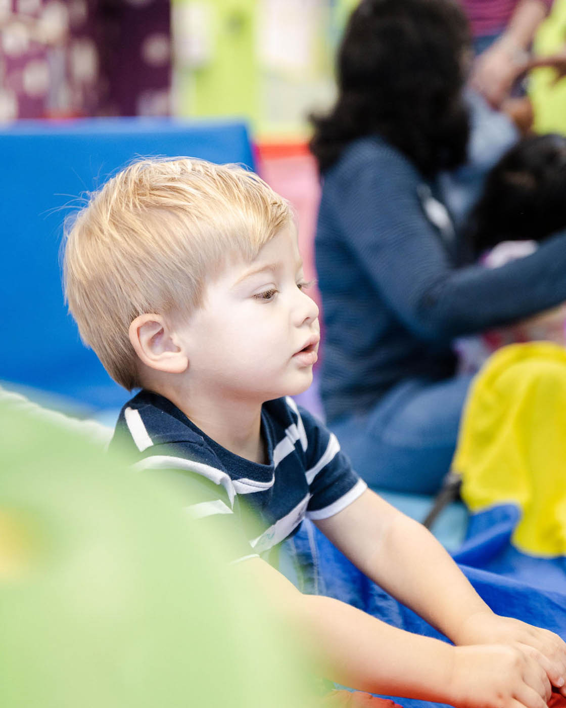 A young boy in a Romp n' Roll facility - we offer a sensory gym for autism in Midlothian, VA.