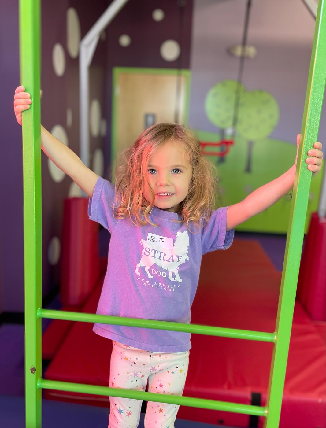 A girl playing in the gym at Romp n' Roll's spring camps.