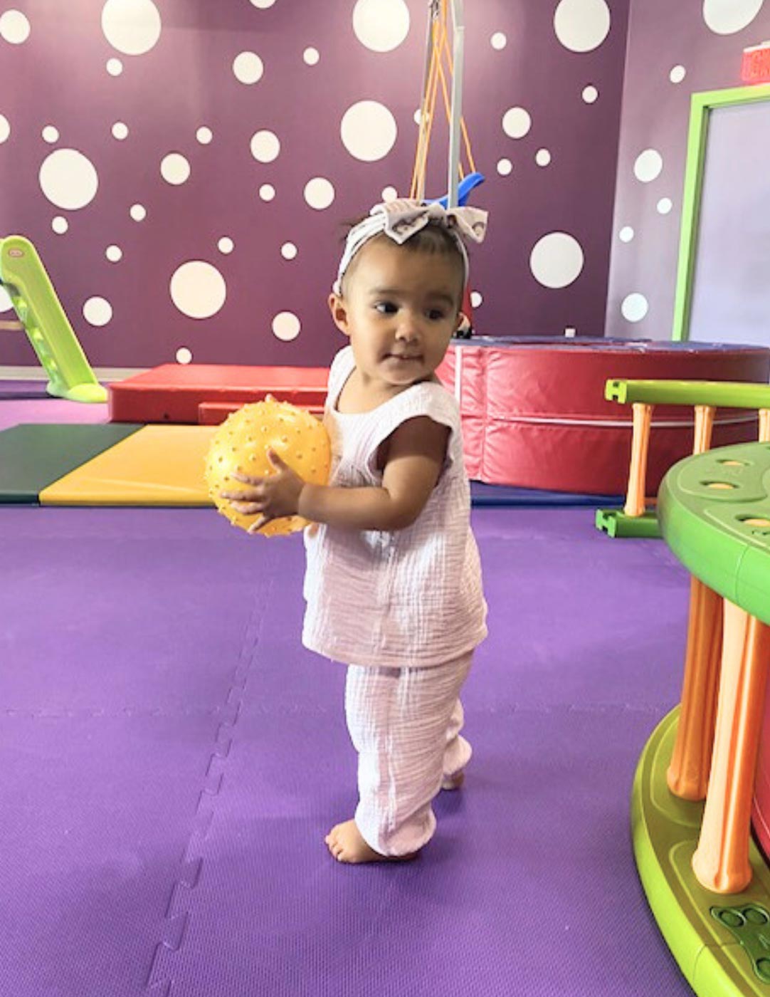 A little girl playing at Romp n' Roll Willow Grove kids gym. 