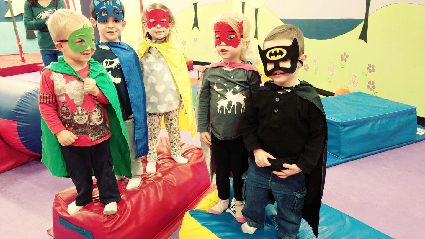 Group of kids having fun in costumes at a Romp n' Roll Katy event.