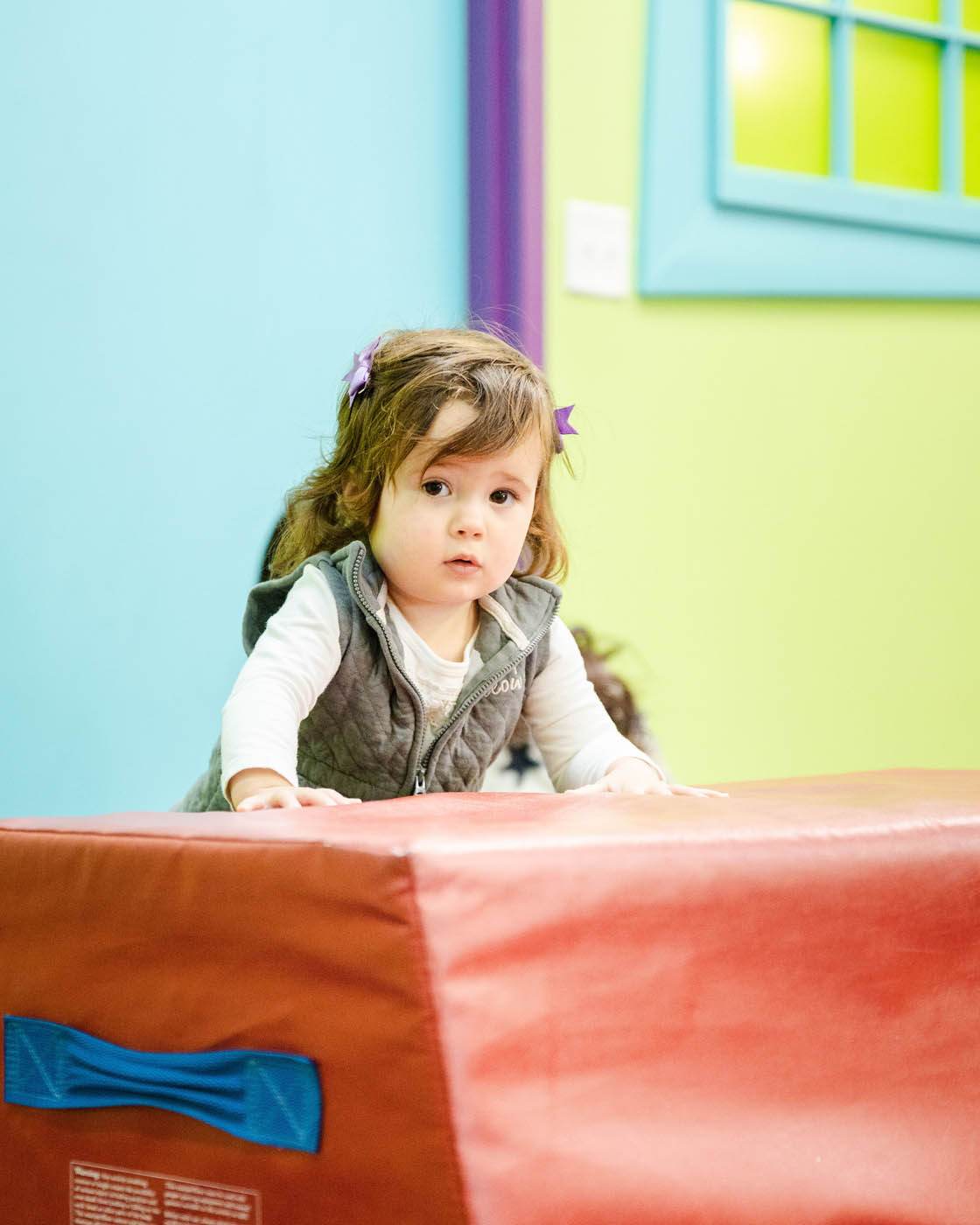 A little baby girl playing on Romp n' Roll West End equipment, Romp n' Roll is your top fun places in Glen Allen, VA.