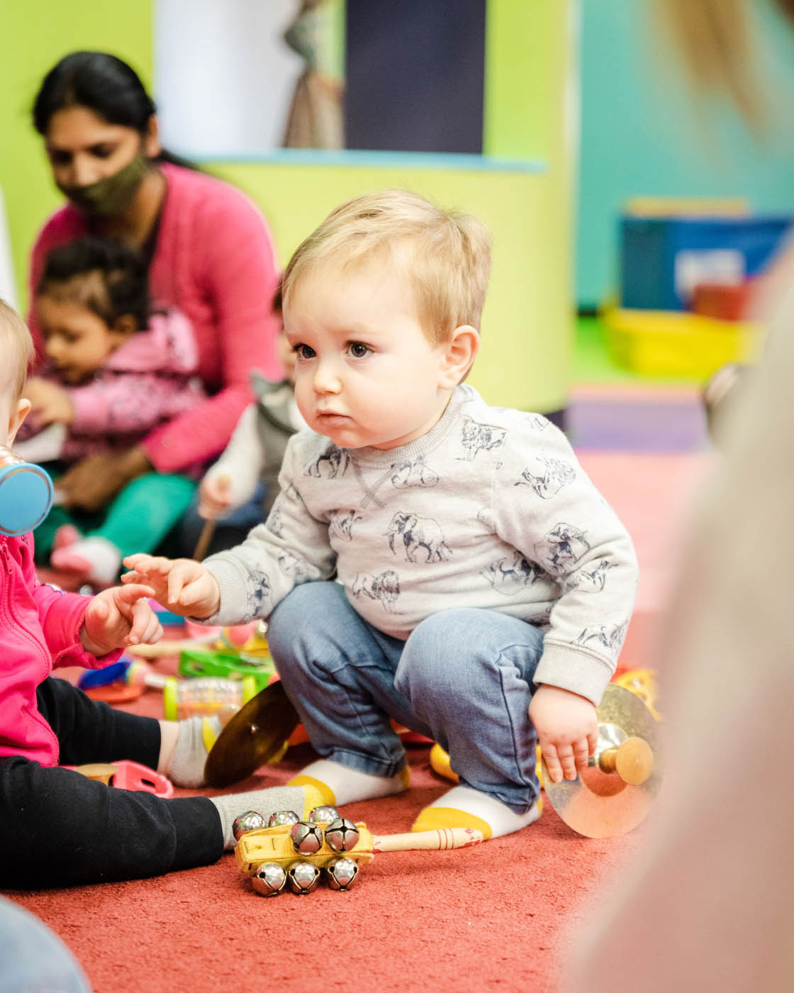 A boy playing with toys at Romp n' Roll - explore our mission and values.