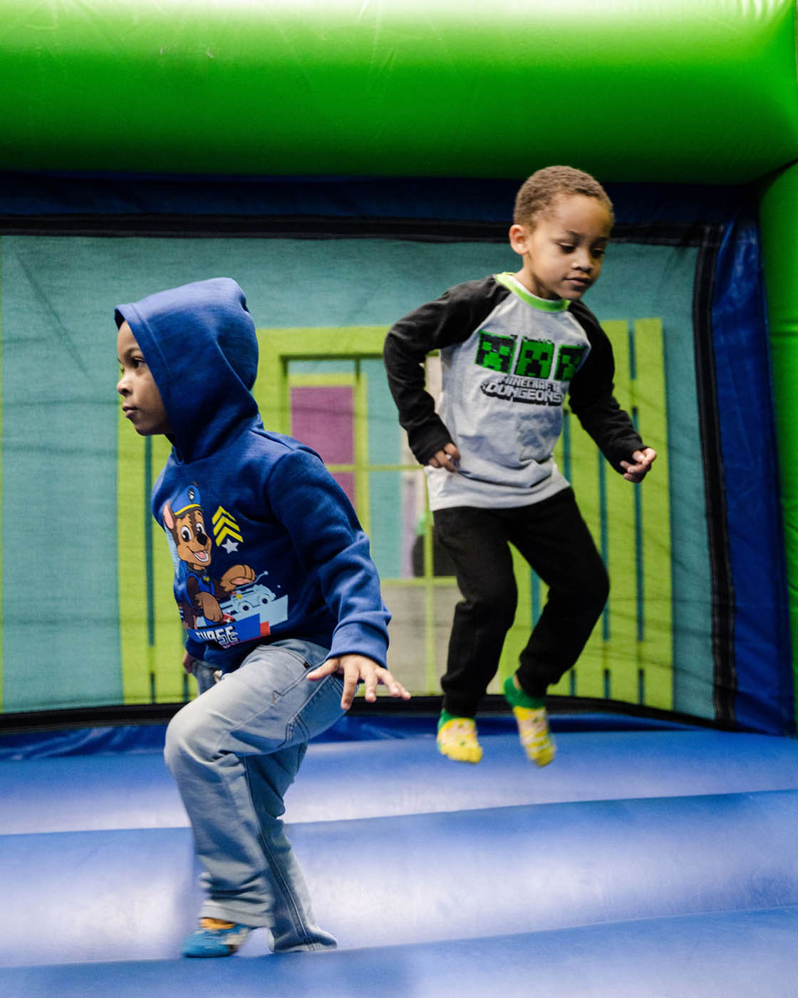 Two boys playing together at a Romp n' Roll gym in Katy.