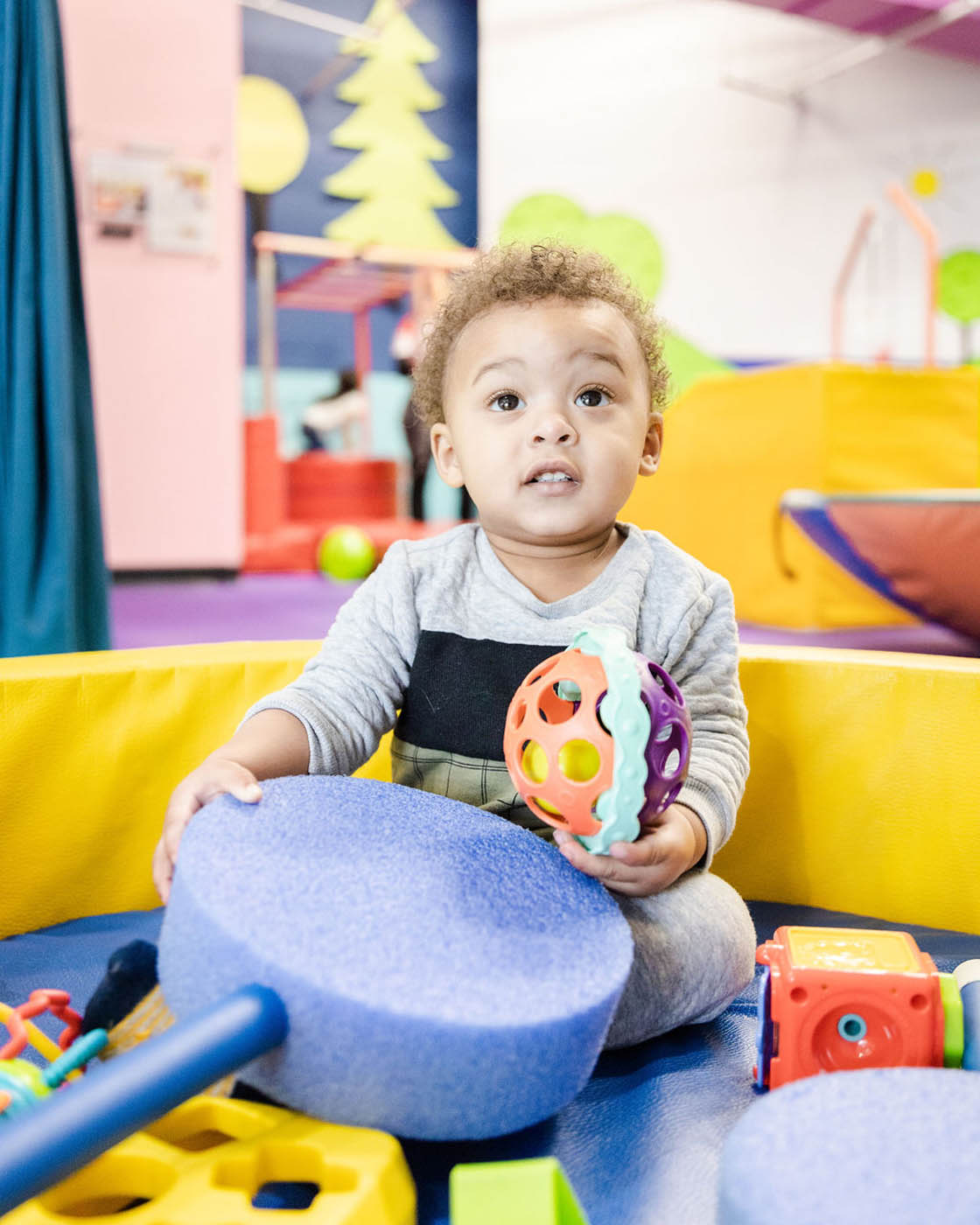 A young boy playin at Romp n' Roll's gym.