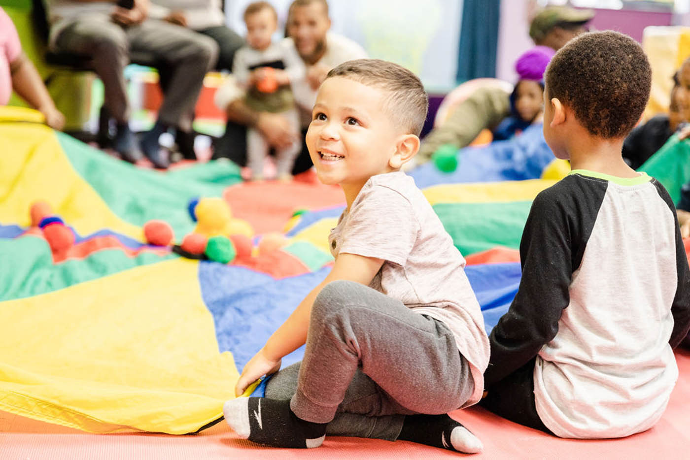 A group of kids and parent playing during one of Romp n' Roll's family friendly activities in Raleigh, NC. 