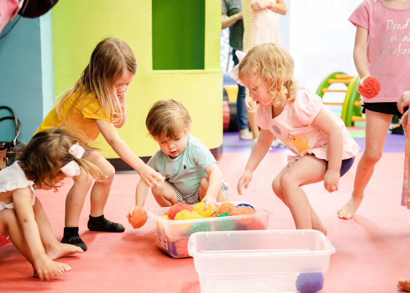 A group of kids playing with toys at Romp n' Roll winter camps for kids in Glen Allen, VA.