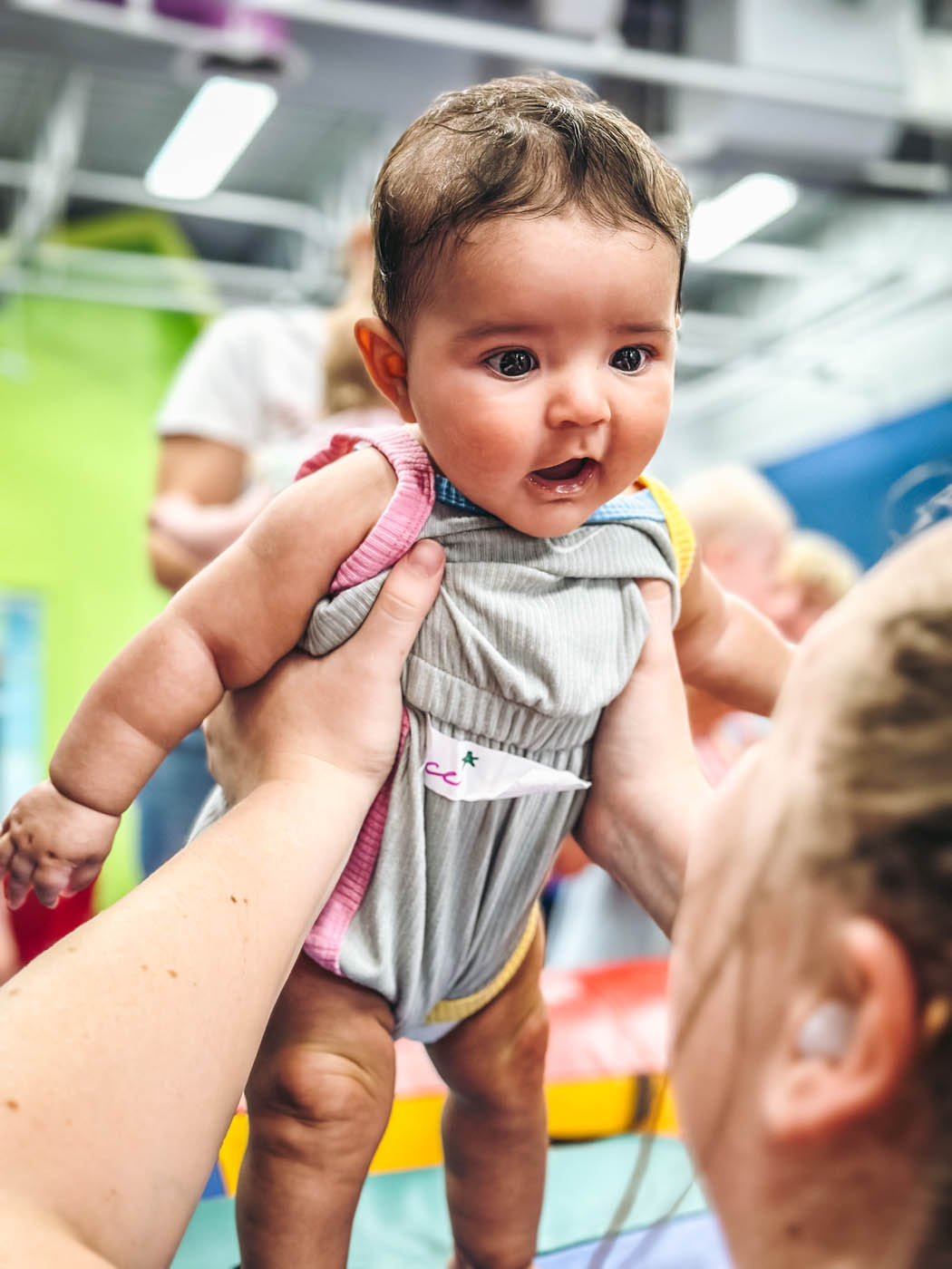 An adult holding a baby at Romp n' Roll in St. Petersburg.