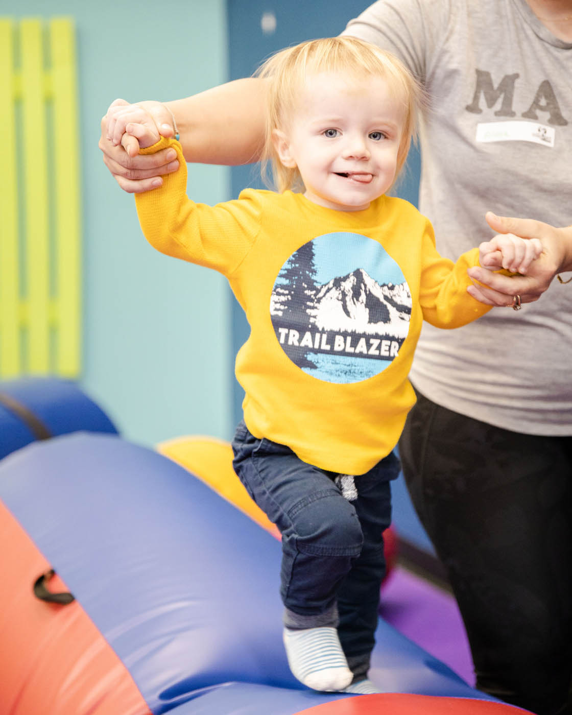 A baby boy balancing on a Romp n' Roll West End gym equipment, contact us today for additional indoor kids activities in Glen Allen, VA.