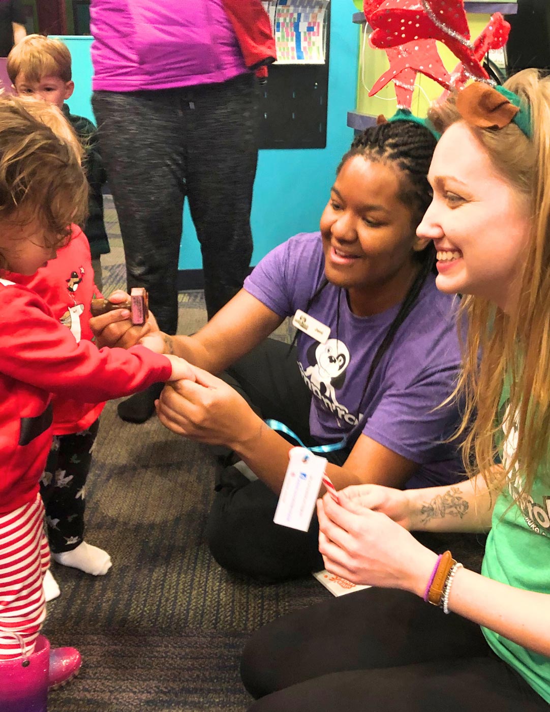 A group of kids playing at a Romp n' Roll class with our staff members.