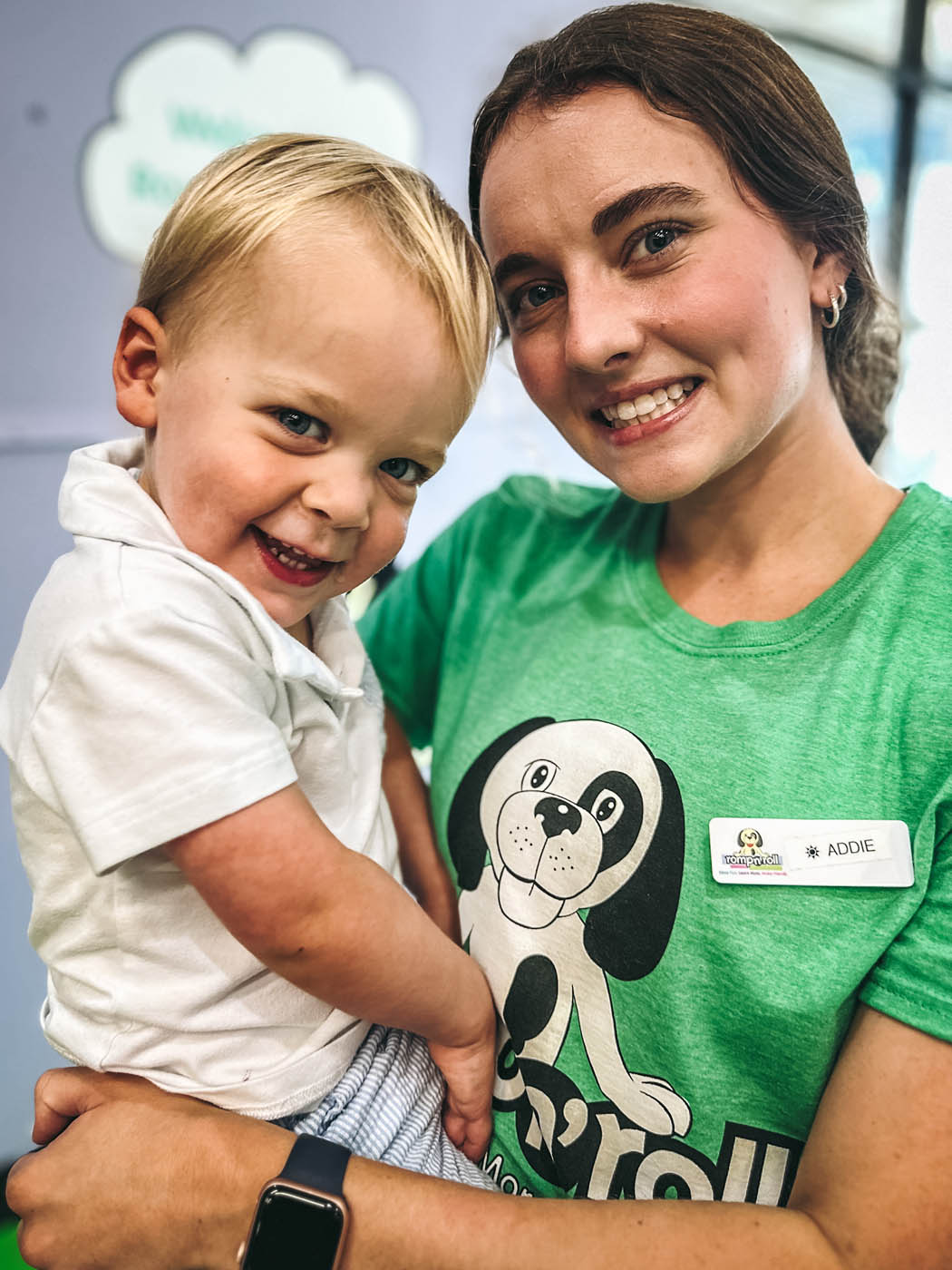 A baby boy being held by one of Romp n' Roll West End's staff members.