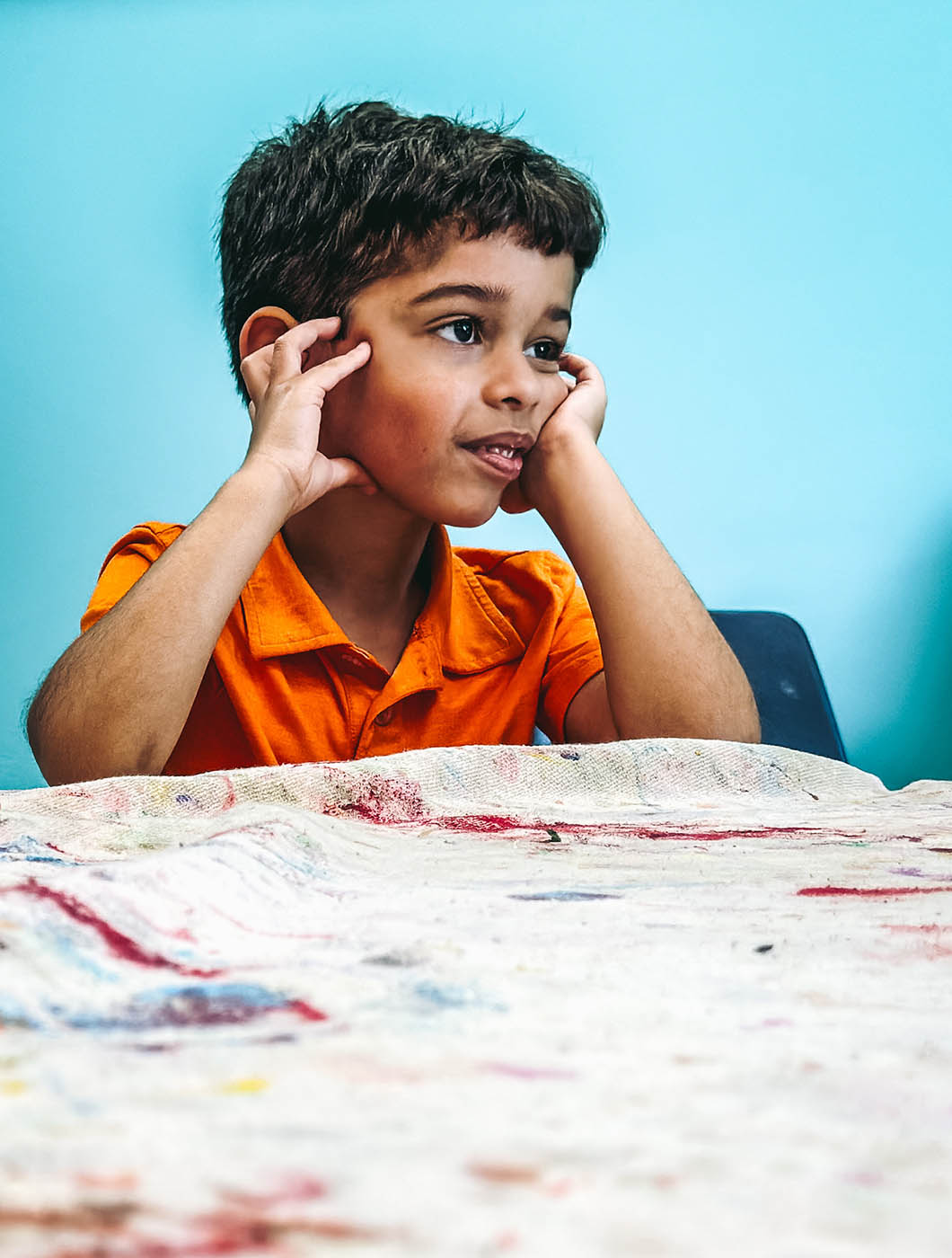 A boy sitting down in a Romp n' Roll class for kids in Pittsburgh. 