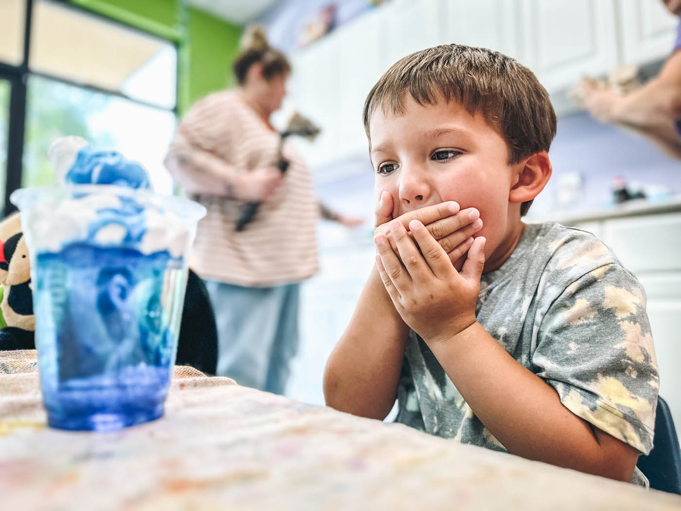 A young boy excited at the science experiment in front of him - Romp n' Roll in Wethersfield.