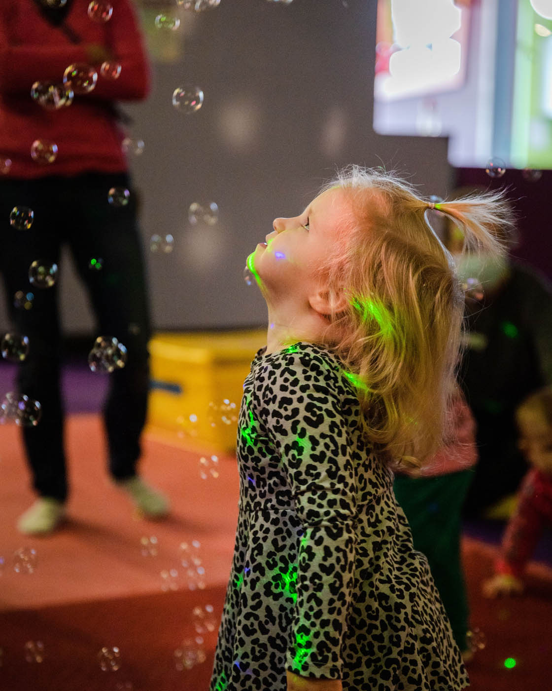 A young girl enjoying bubbles and dance classes at Romp n' Roll in Midlothian.