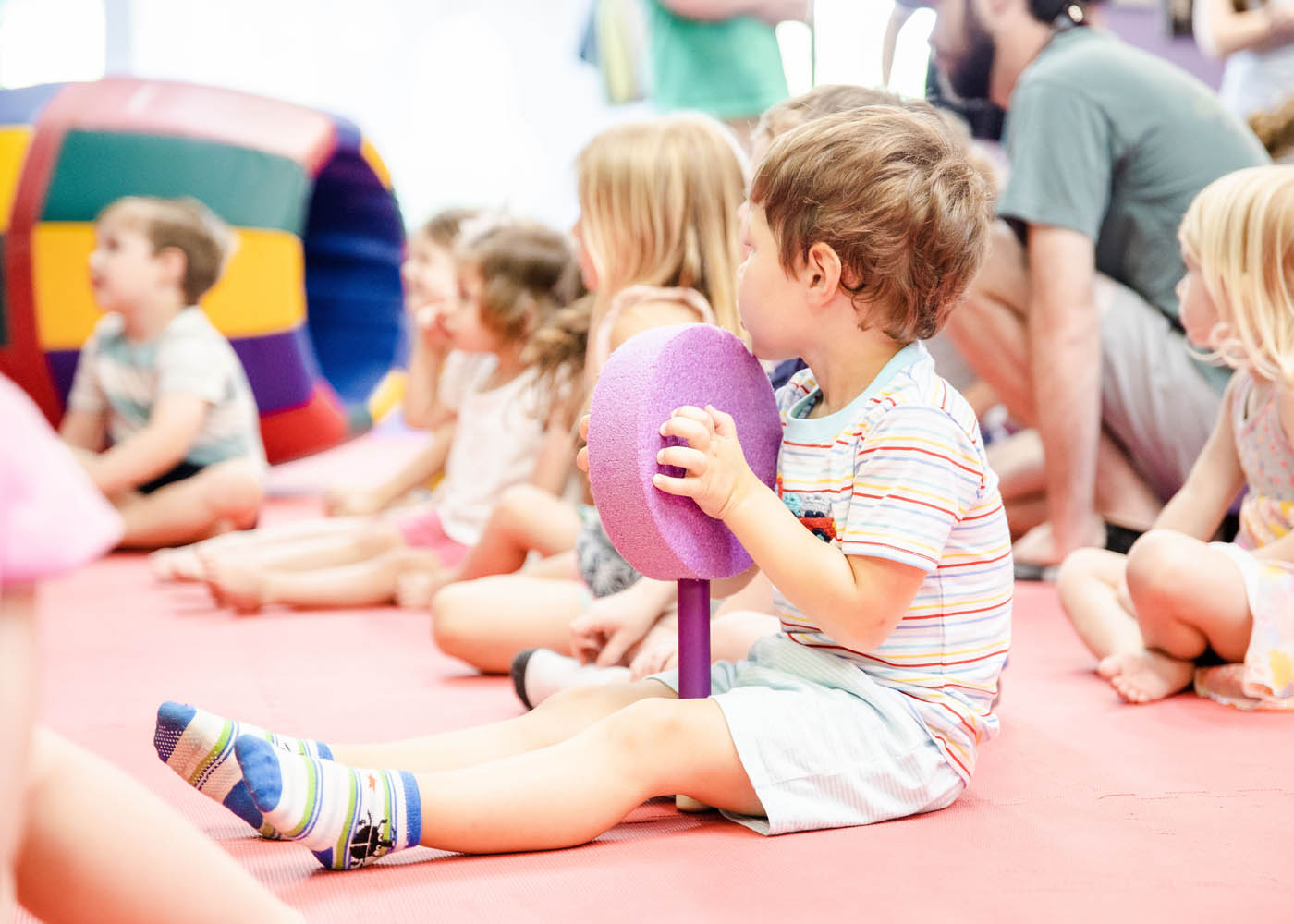 A little boy playing with music instuments at Romp n' Roll, choose us for your kid play area in Glen Allen, VA.