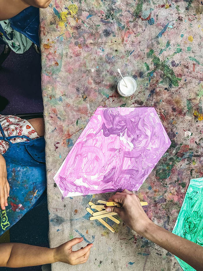 An image from above of multiple kids enjoying the art class with Romp n' Roll in Katy.