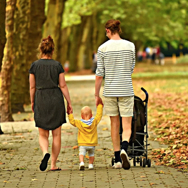 This family is taking a walk in the fall weather - learn more tips to stay active with your kids with Romp n' Roll in Raleigh, NC.