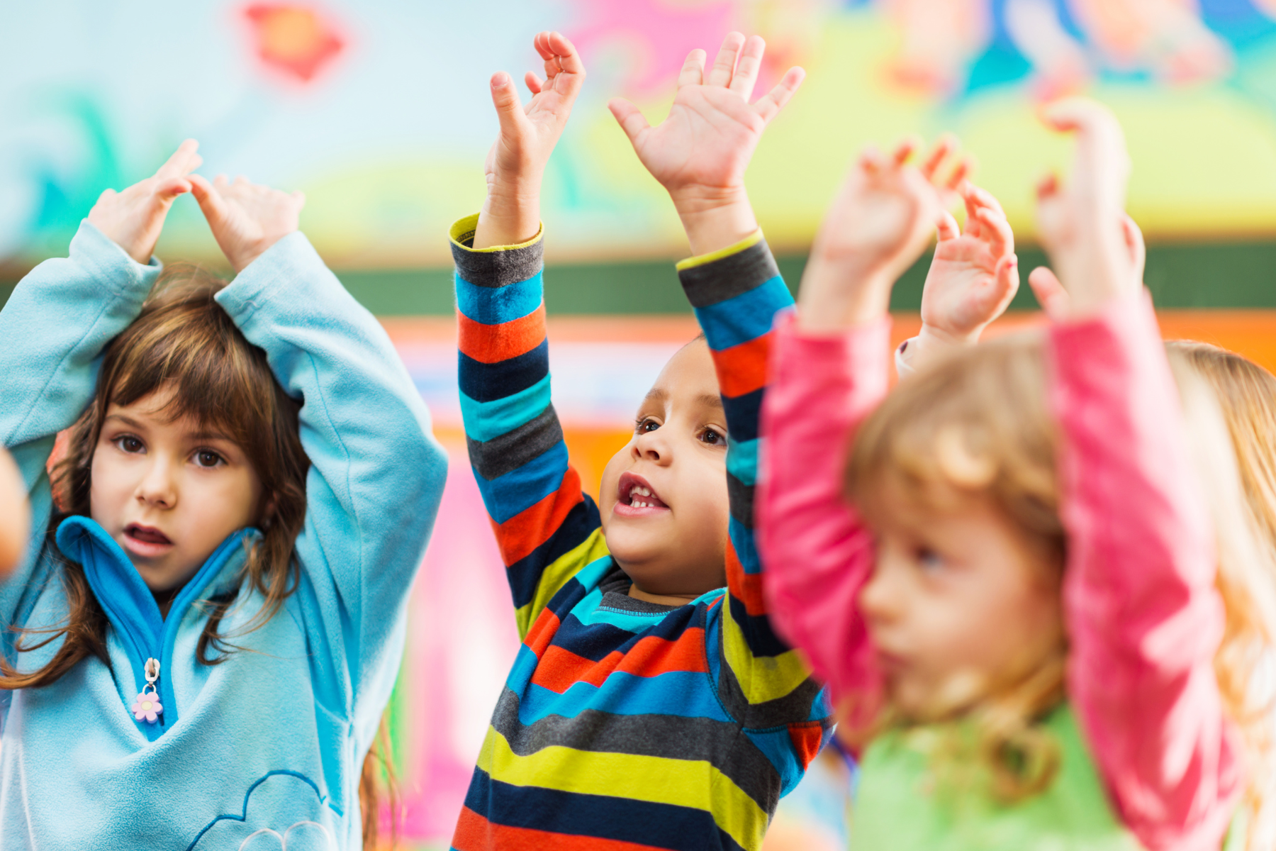 A little boy dancing to the music with bubbles at dance classes for 3 year olds with Romp n' Roll.